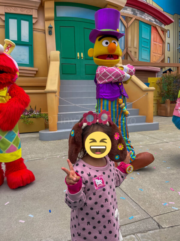 a child next to sesame street characters in imagination playland universal studios japan