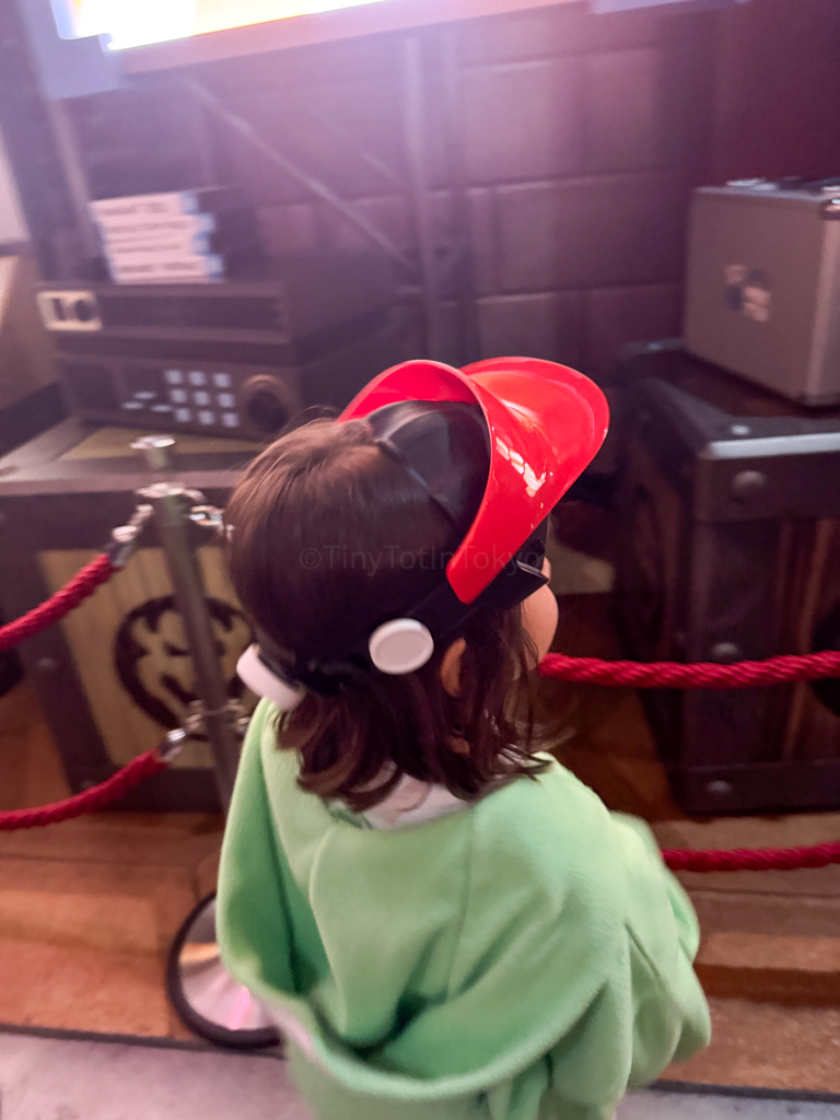 a child at age 5 wearing the Mario Kart visor at USJ