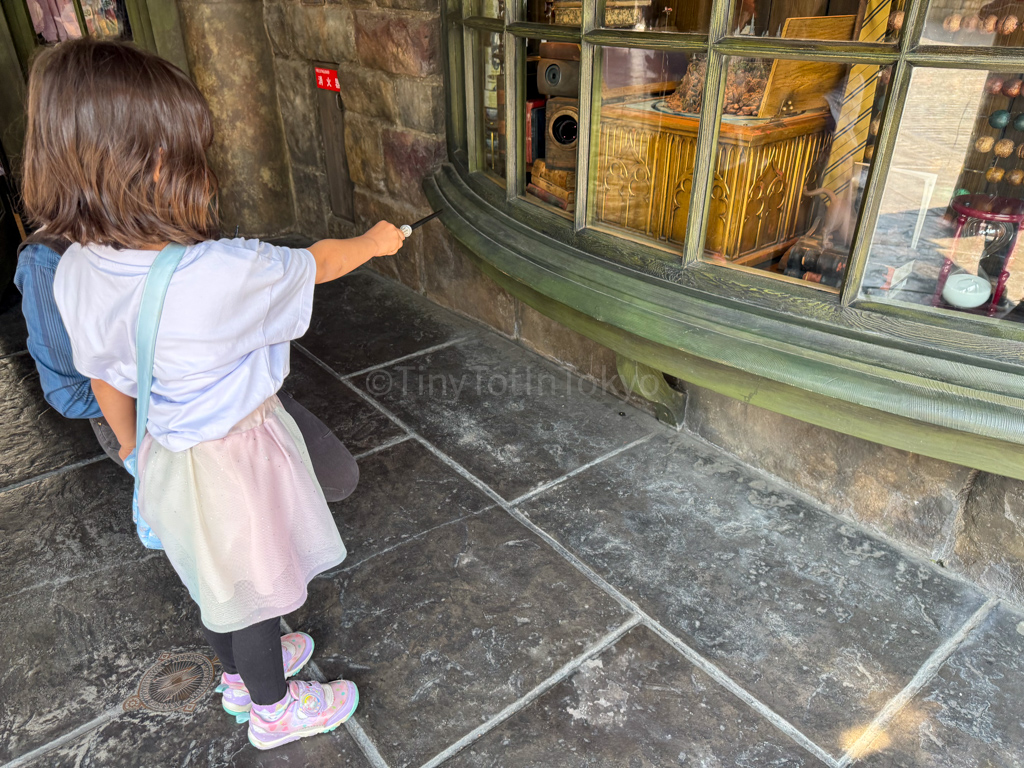 a child doing Harry Potter wand magic at Universal Studios Japan