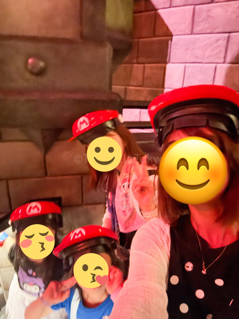 the author, her friend, and their children wearing Mario Kart hats at Universal Studios Japan
