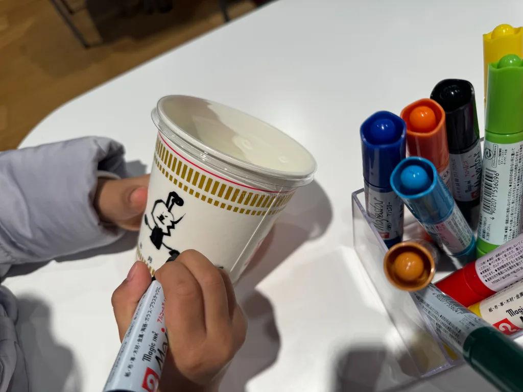 drawing on cup noodles cups at the cup noodle museum