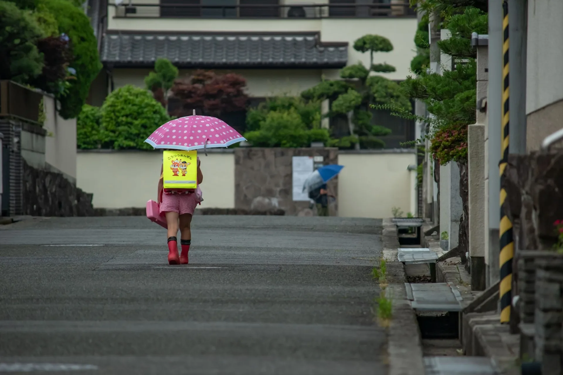 Kid walking in the rain in Kyoto