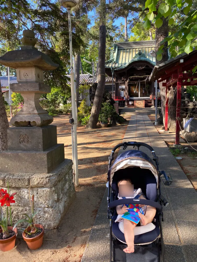 baby in a stroller at a shrine in Japan