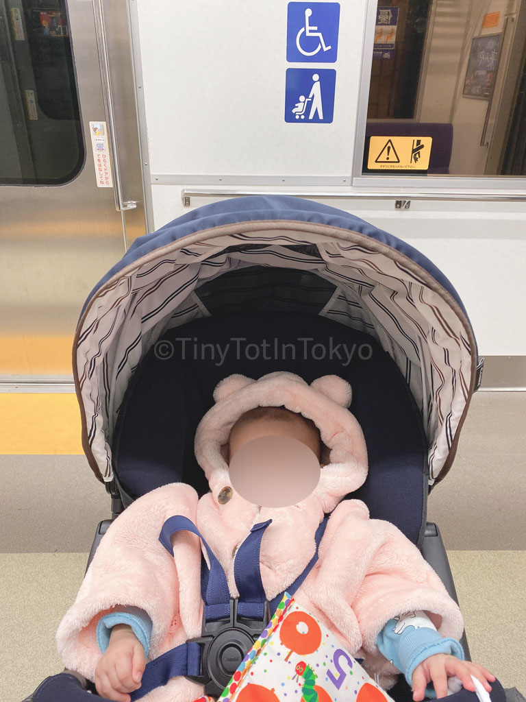 baby in stroller at train station in japan