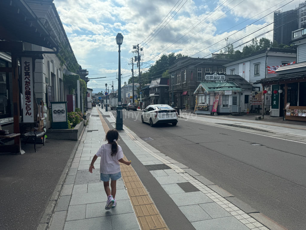 Kid walking along Sakaimachi Hondori Street in Otaru Hokkaido