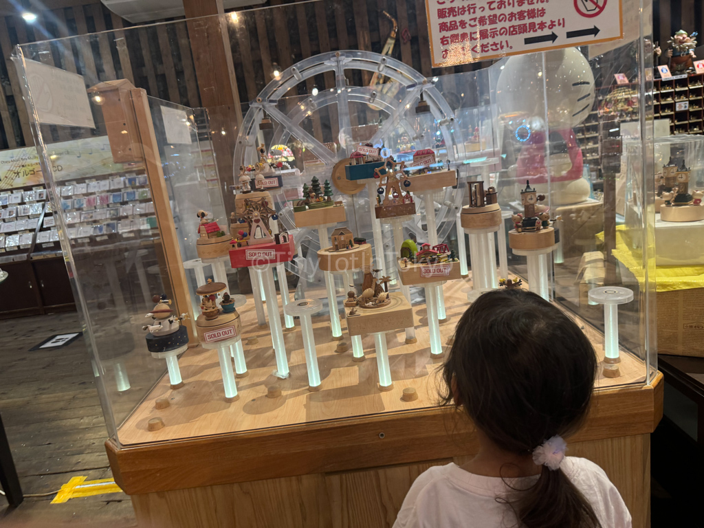 kid looking at music boxes in Otaru Hokkaido