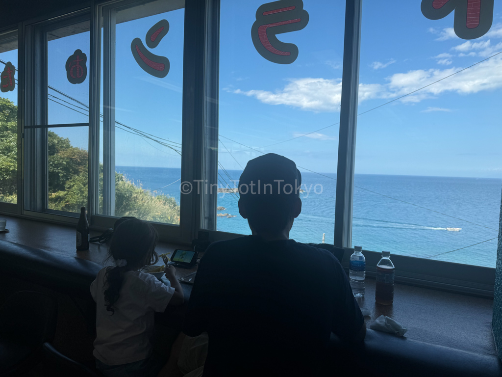 man and child at a restaurant at otaru aquarium in hokkaido