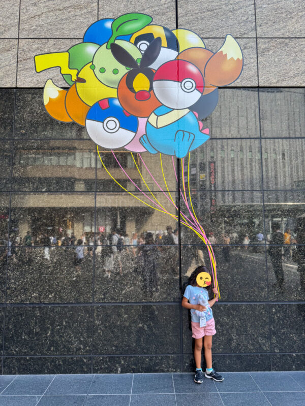 child holding pokemon balloons in Japan