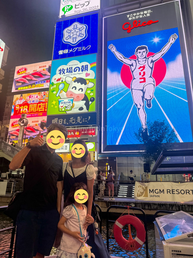 family photo in front of glico man in Dotonbori Osaka