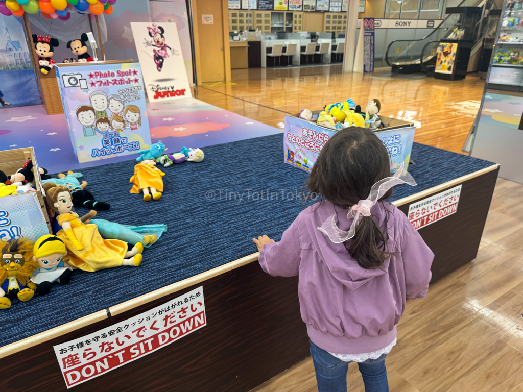 a kid looking at disney toys at yamada denki in namba osaka