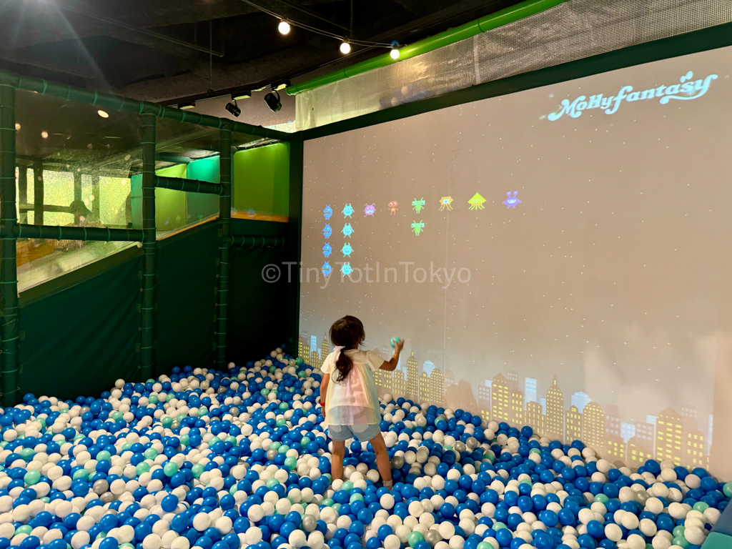 Girl in a ballpit at Mollyfantasy indoor playground