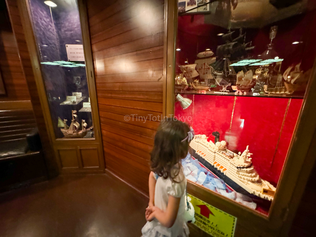 A child looking at a display of a ship on the Santa Maria in Osaka