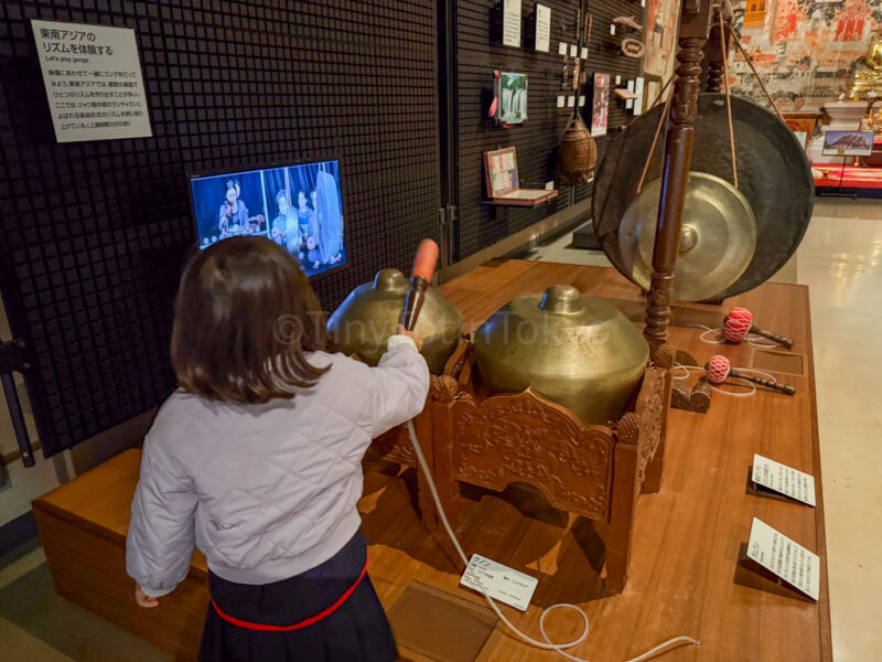 a child playing instruments in the national museum of ethnology in osaka
