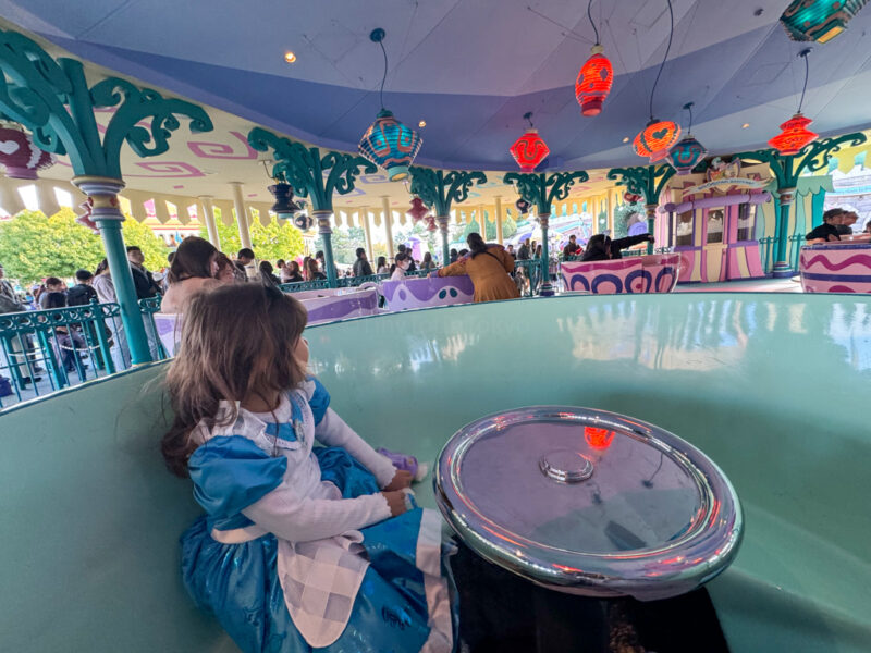 A child on the Alice teacups ride at Tokyo Disneyland