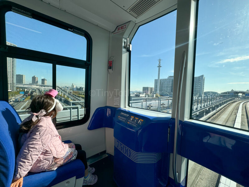 Child sitting on train going to teamlab planets in Odaiba
