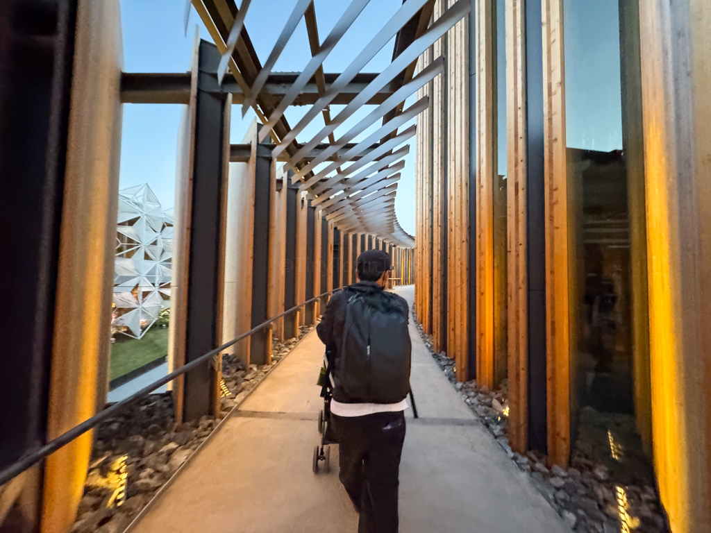 a man walking outside the Japan Pavilion at Osaka Expo