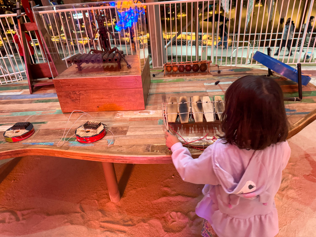 child playing instruments at jellyfish pavilion at osaka expo