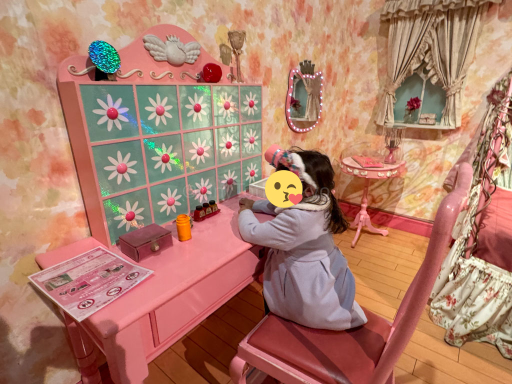 A girl sitting at a table in the kitty caste at harmonyland