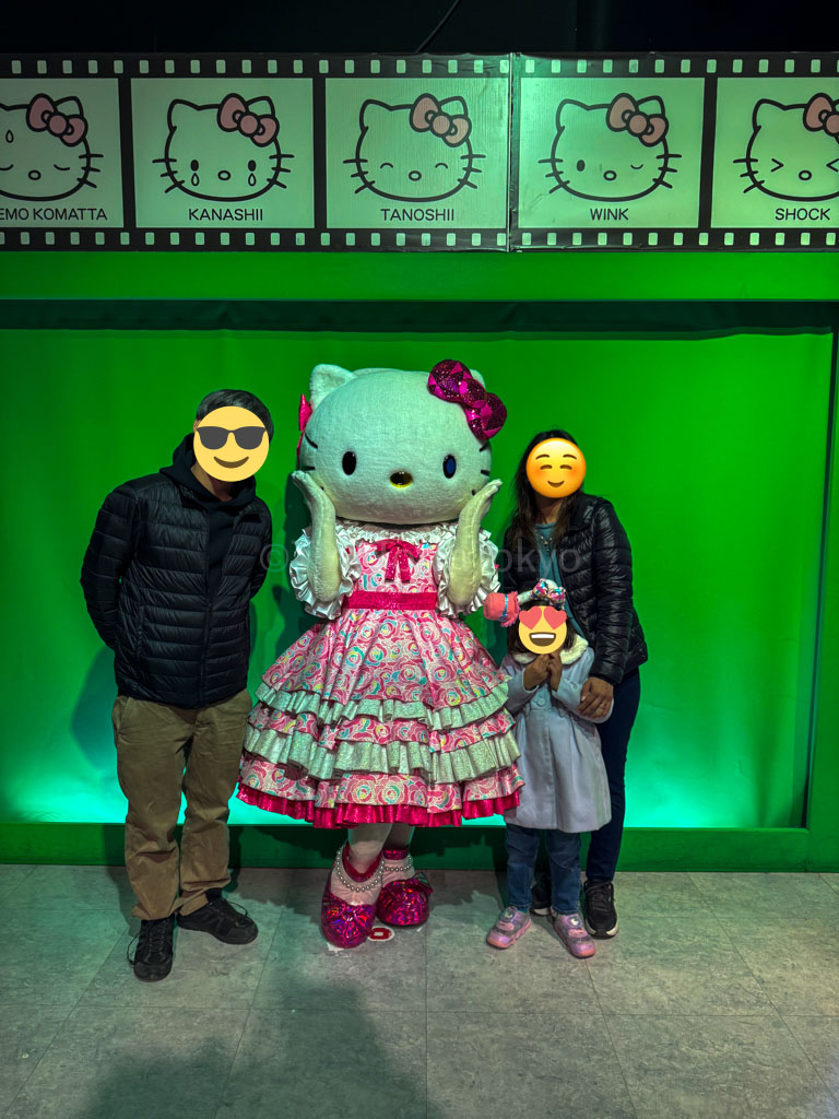 A family posing with hello kitty at harmonyland
