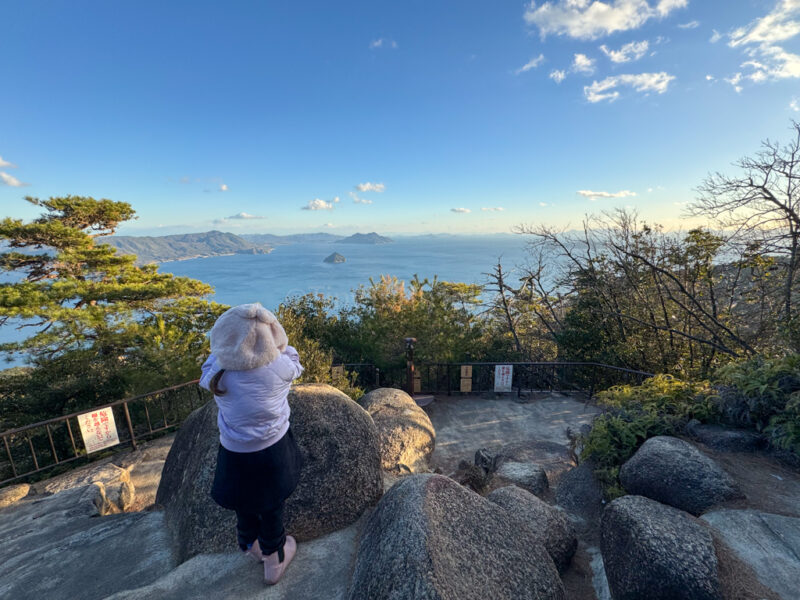 A child looking at the view from Shishiiwa Observation Deck in Miyajima