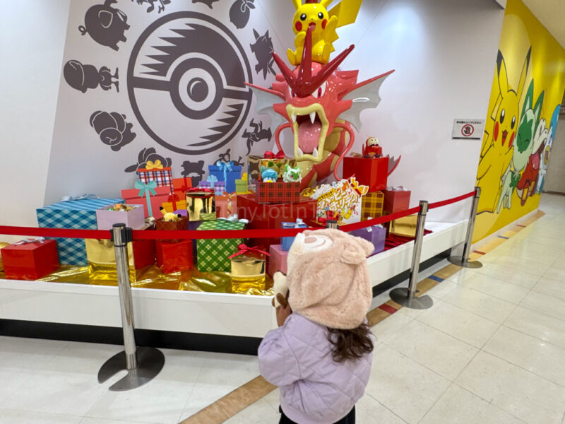 a child standing in front of the Pokemon Center in Hiroshima