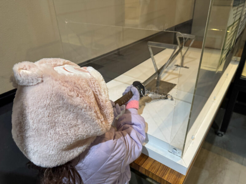 A child holding a katana in Hiroshima Castle