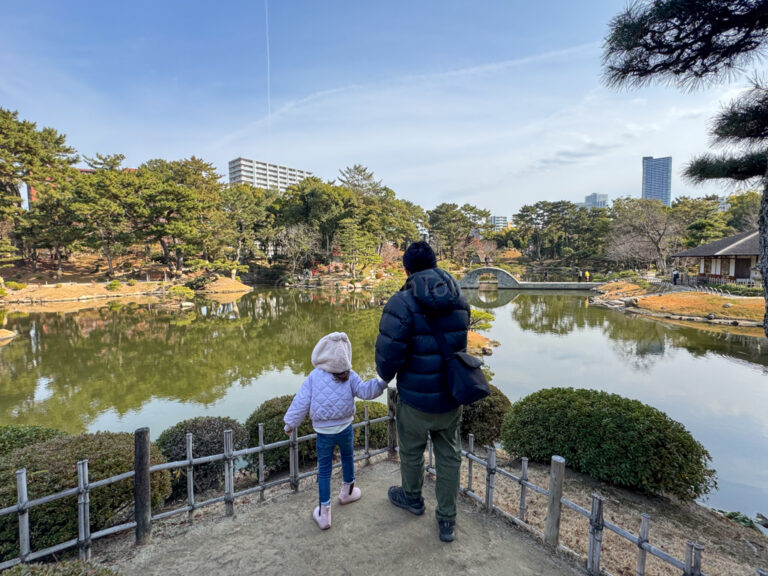 A child and parent standing in Shukkeien Garden in Hiroshima