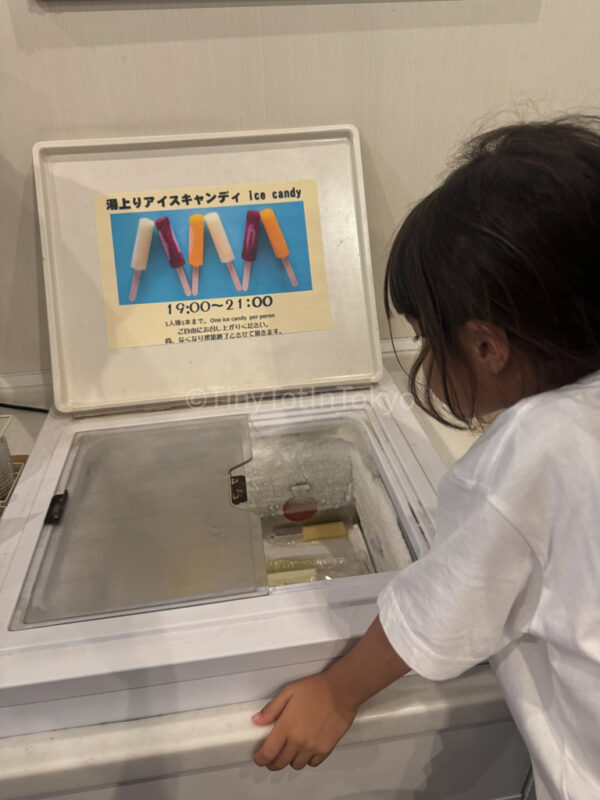 A child getting a free popsicle at a hotel in Furano