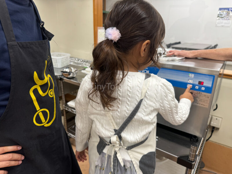 A child making ice cream at Furano Cheese factory