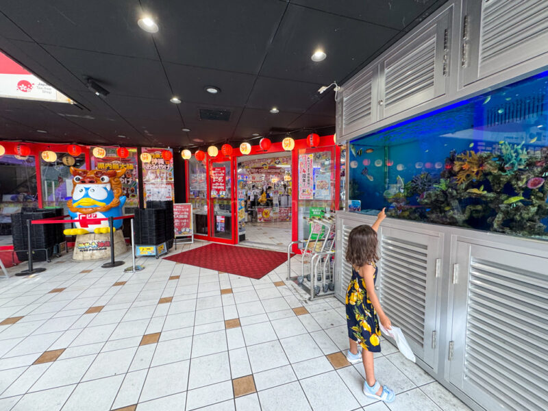 A child in front of the Donki Souvenir shop in Okinawa