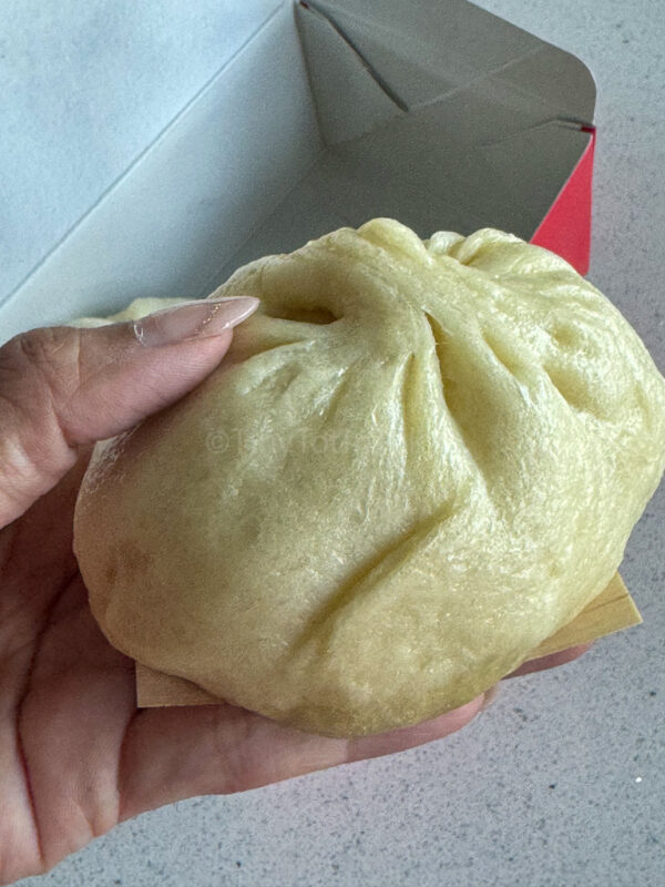 holding the pork bun butaman from 551 Horai