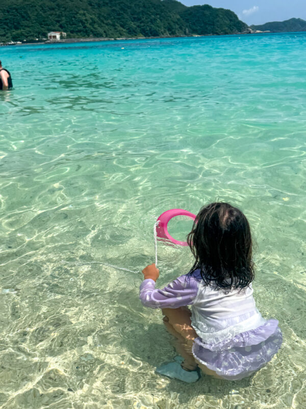 A child playing at aharen beach on Tokashiki Island