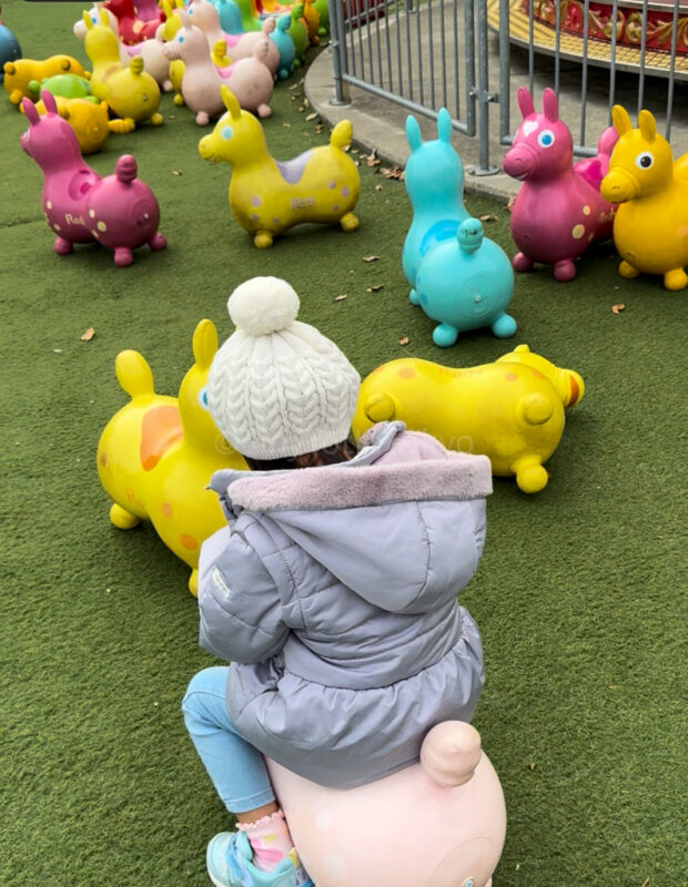 a child riding on a toy horse at Amanohashidate