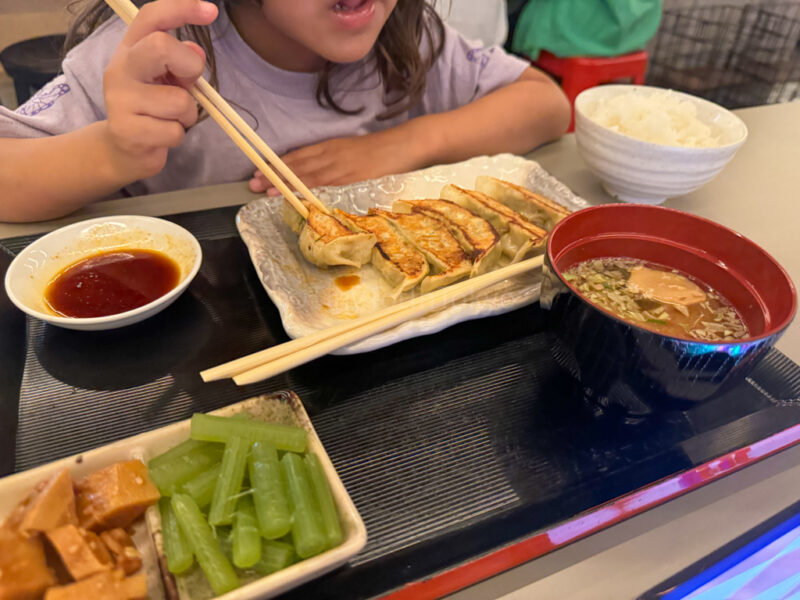 a child eating Gyoza at Kyoto Tower