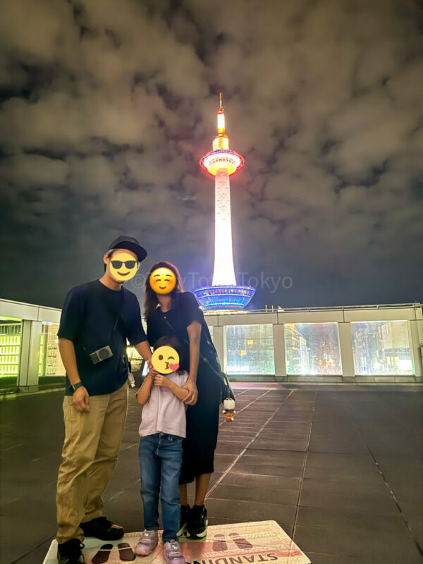family in front of kyoto tower