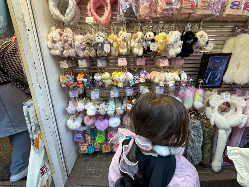 a child looking at hair accessories in Harajuku
