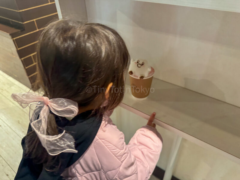 a child looking at a kirby latte in Harajuku
