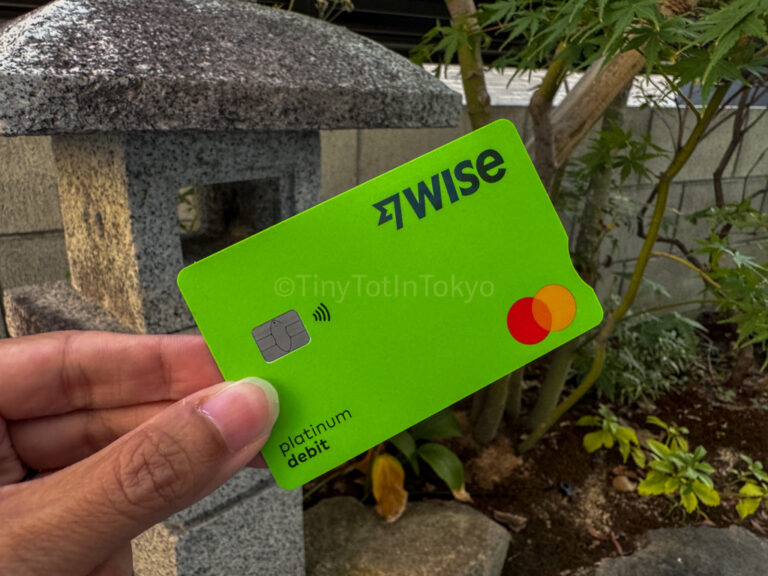 author holding a Wise card in Japan