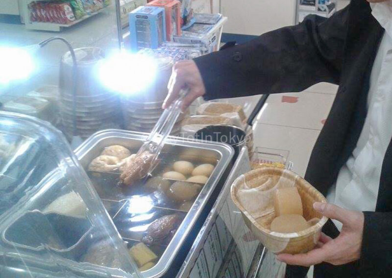 a man trying oden from a convenience store in Japan