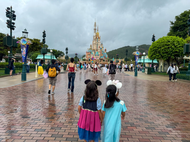 Kids walking to castle of magical dreams at hong kong disneyland 