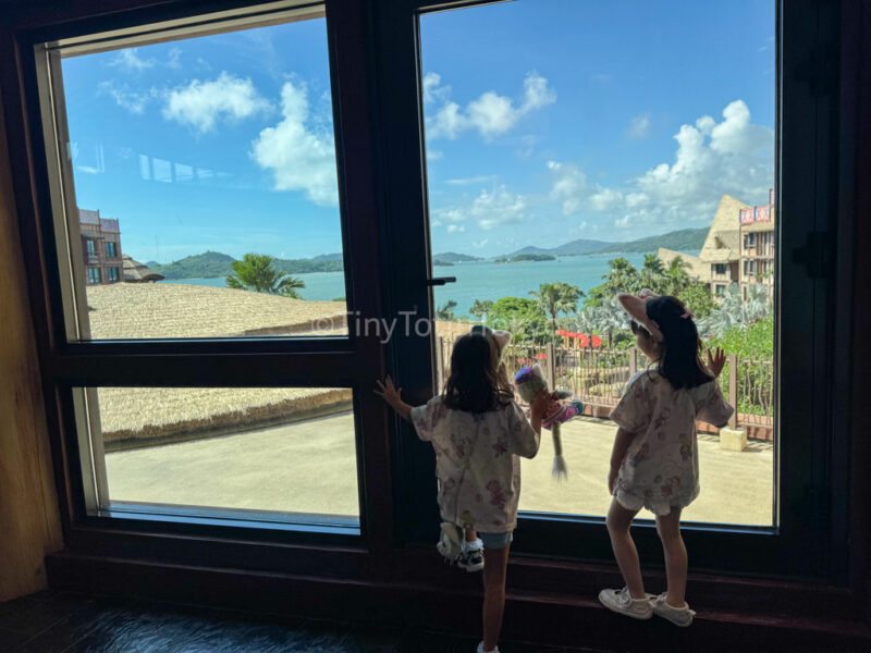 Kids looking at the view of the south china sea from Hong Kong Disneyland Explorers Lodge 