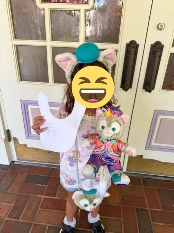 a child holding a gelatoni stuffie and signature at Hong Kong Disneyland