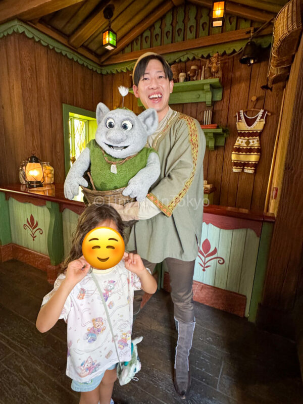 a child inside Wandering Oaken's Sliding Sleighs meeting a troll at Hong Kong Disneyland