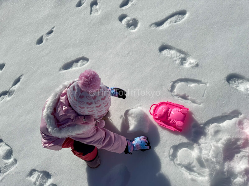 a child playing in snow in Japan