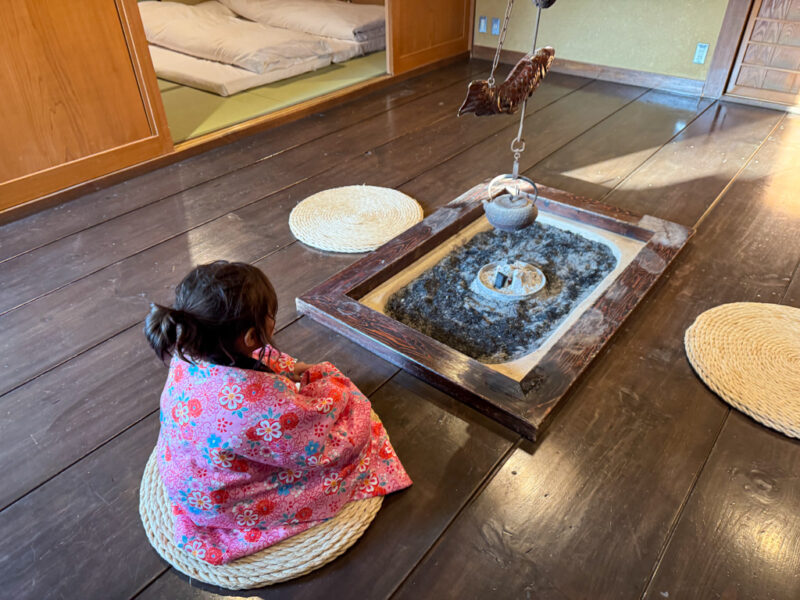 child enjoying the hearth at Yama no Hotel Musouen in Yufuin