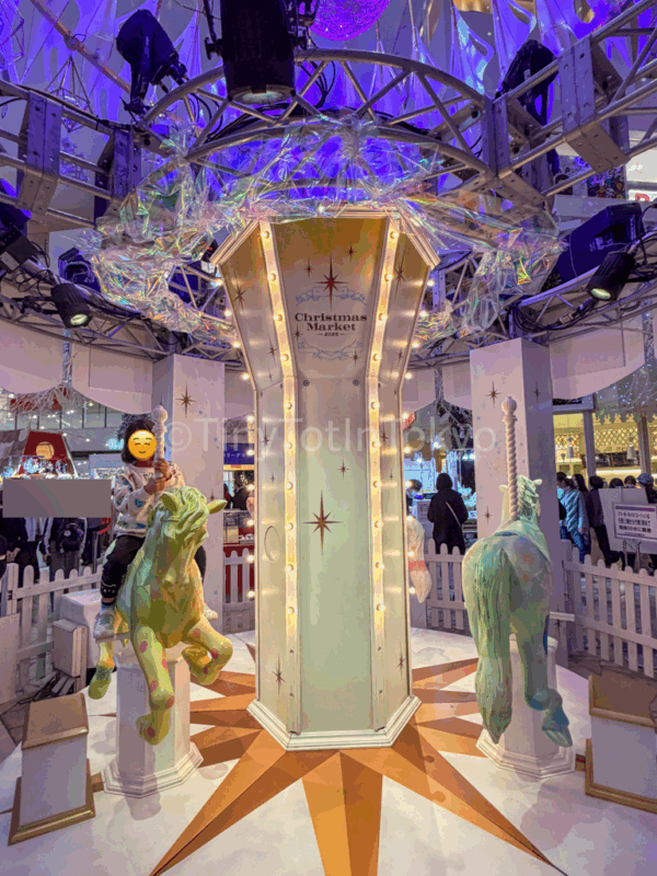 a child on a Merry go round at hankyu Christmas markets in Osaka
