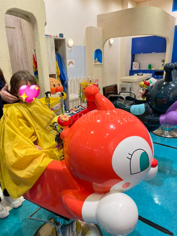 a child getting their haircut at the anpanman museum in Kobe
