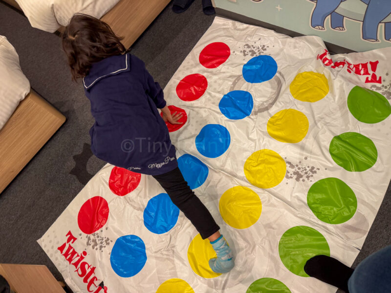 a child playing Twister at Mimaru Japan Pokemon hotel room