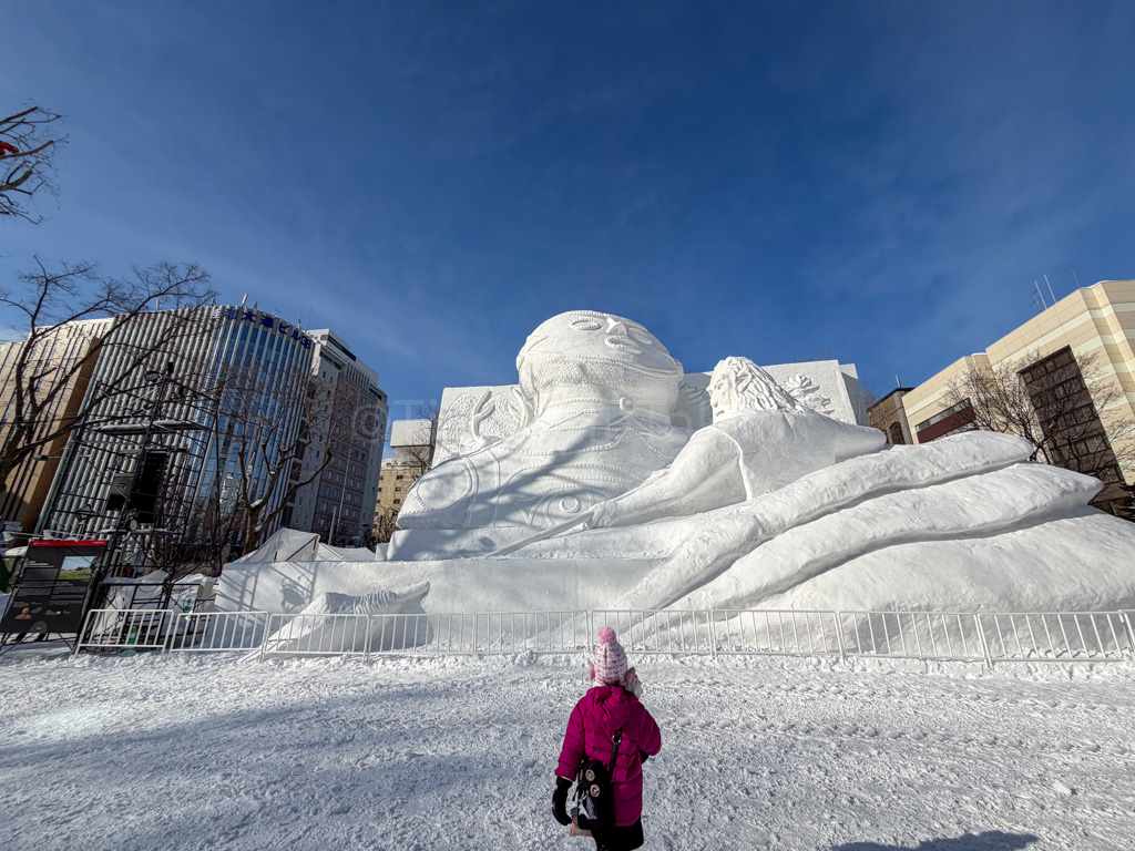 a child in front of a snow sculpture at yuki matsuri