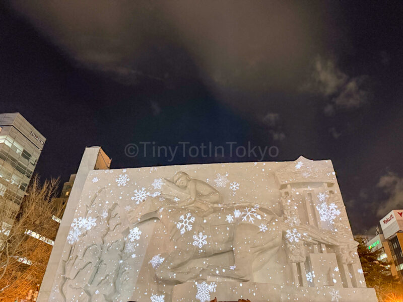 large snow sculpture lit up at night at Yuki Matsuri